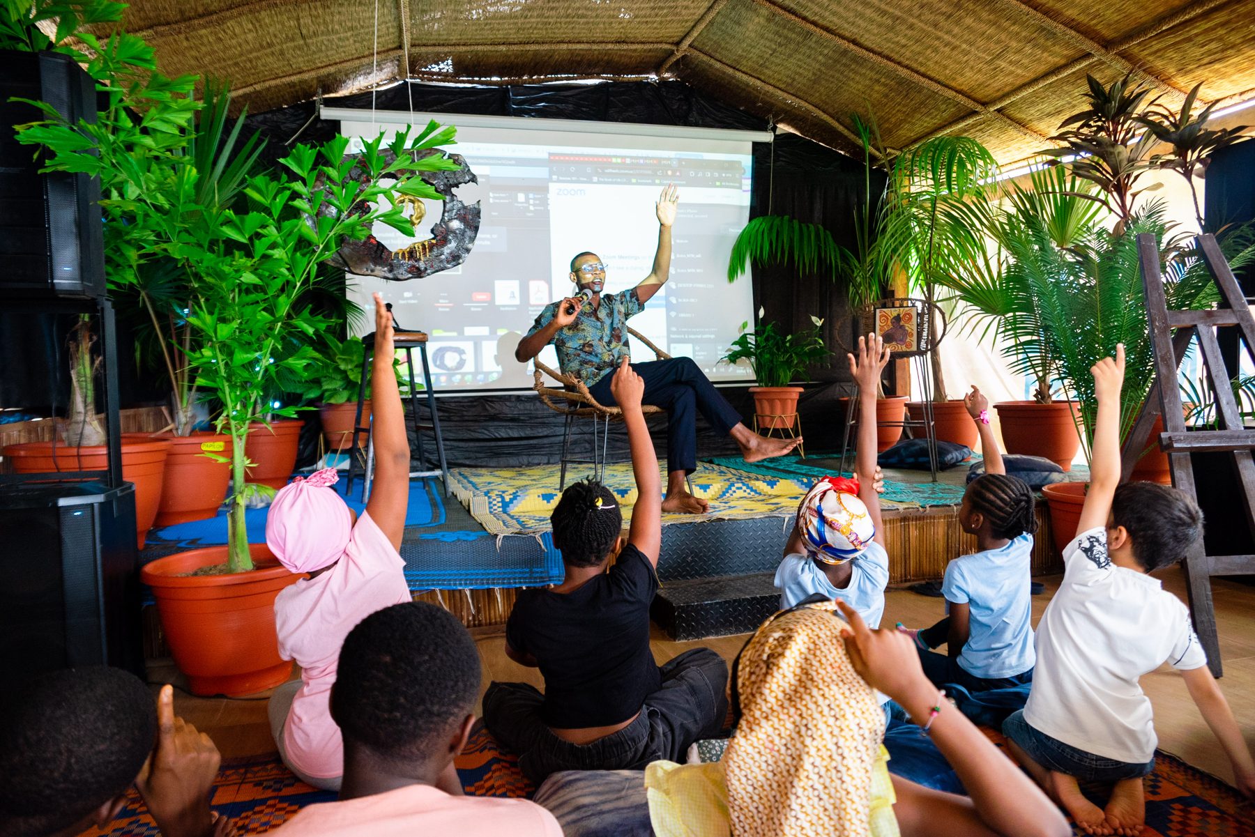 Learners raising their hands during a Climate-Safe Schools classroom session