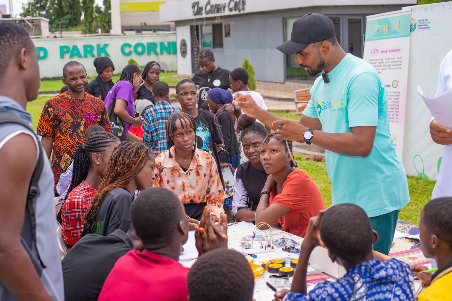 A facilitator guiding learners through a hands-on school club project