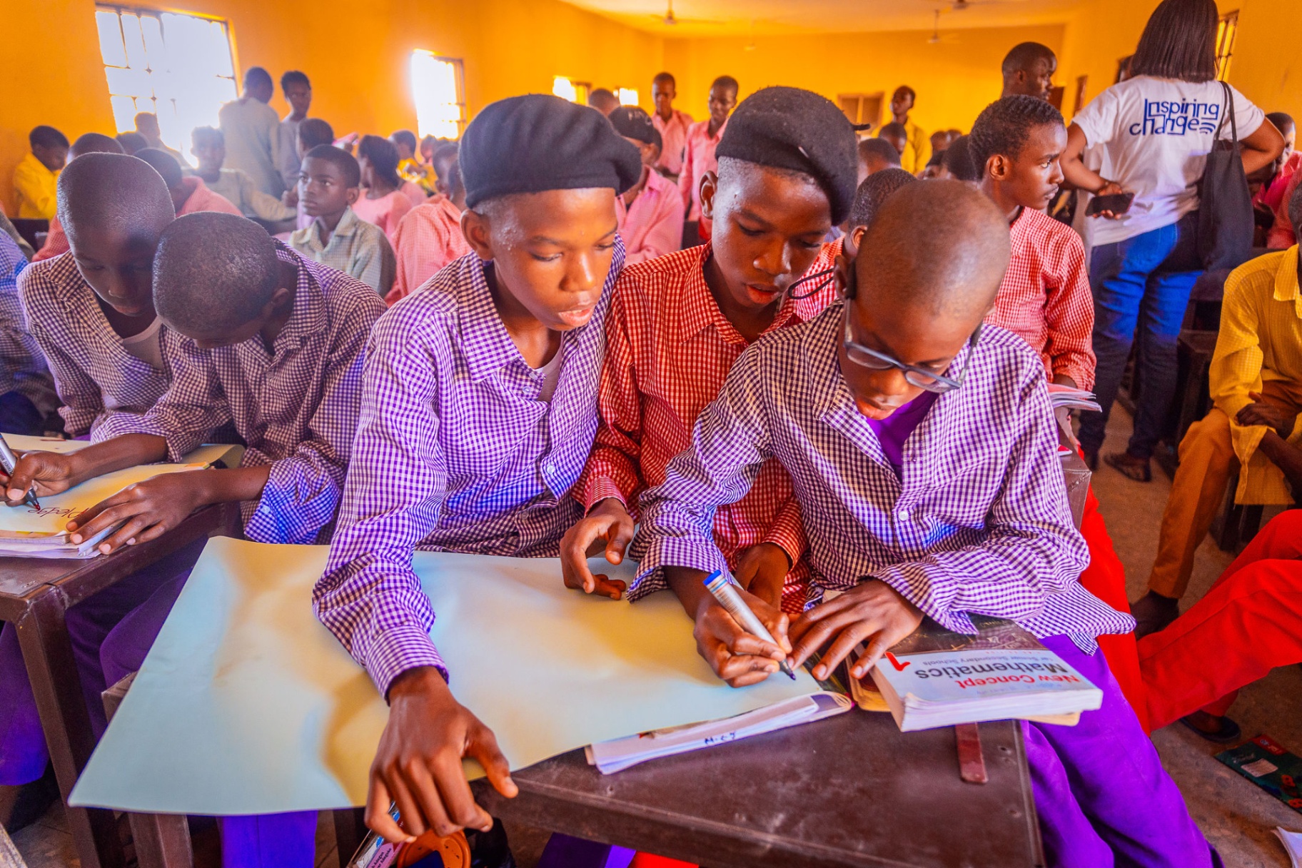 African school children in uniforms attentively learning in a classroom
